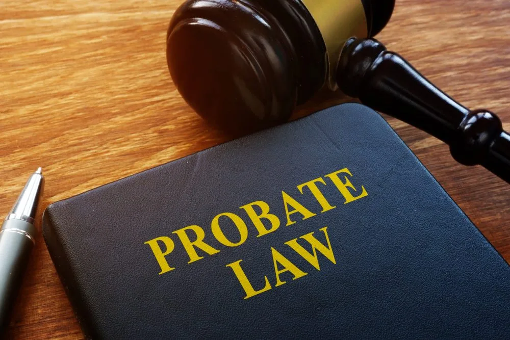 A probate lawyer helping a client with the probate process using a gavel and a probate law book on the table