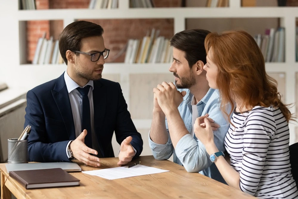 A couple consults with a lawyer, symbolizing their preparation for the role as guardians in Florida.