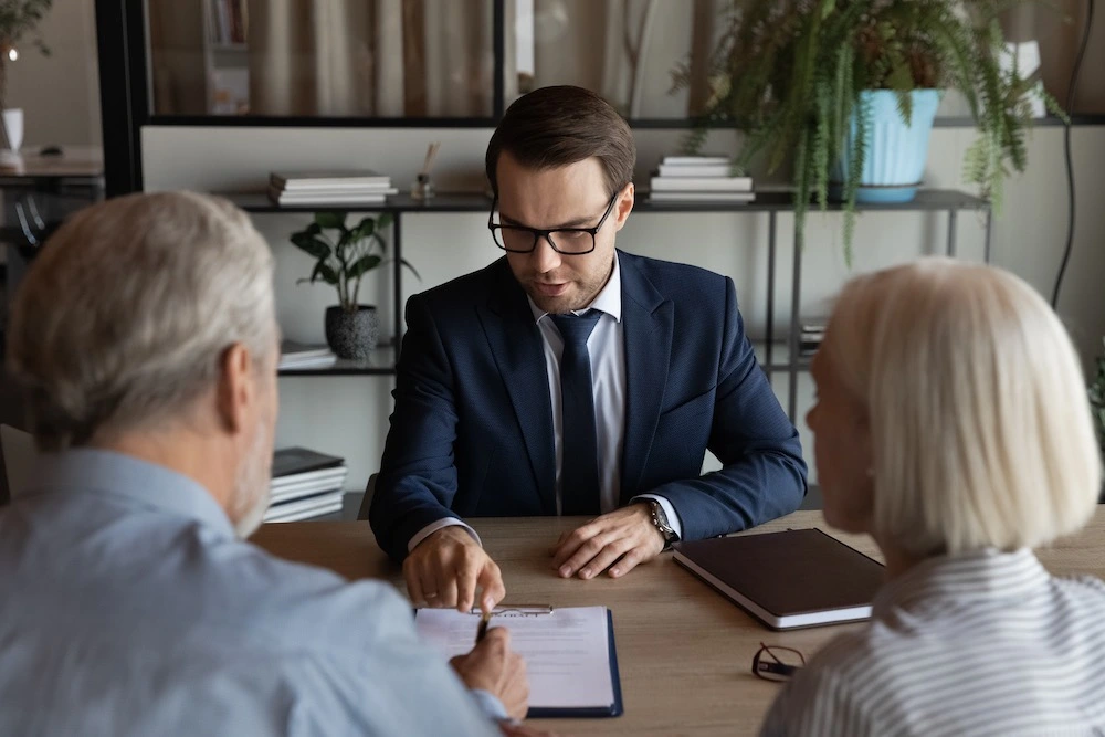 Concerned family members discuss a petition with a lawyer, seeking guidance and clarity.