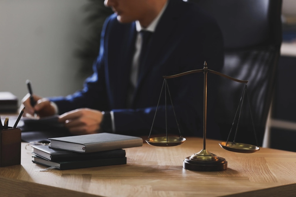 A lawyer in an office pores over legal documents representing the Marchman Act.