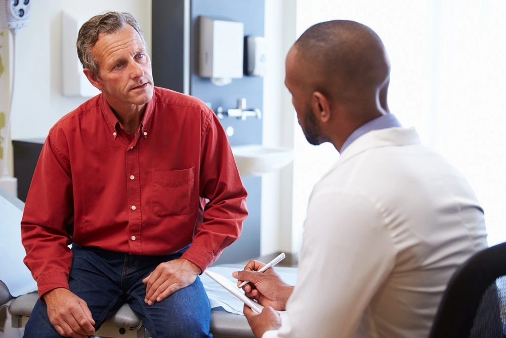 A person discusses with a doctor, representing the legal rights and protections under the Marchman Act and the role of healthcare professionals.